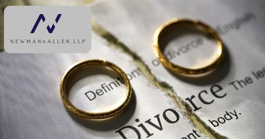 two wedding rings on opposite ends of a divorce paper torn in half