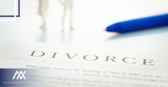 divorce paper and pen, two people standing in the background